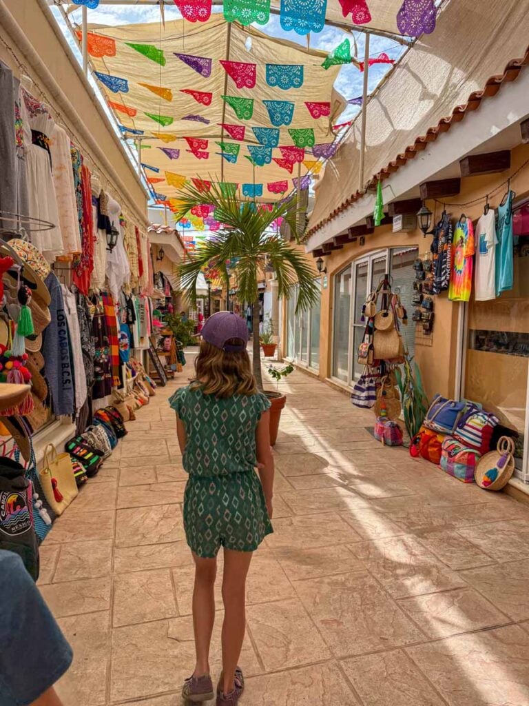 a 12-year old girl walks through the colorful Plaza Artesanos during a family trip to San Jose del Cabo, Mexico.