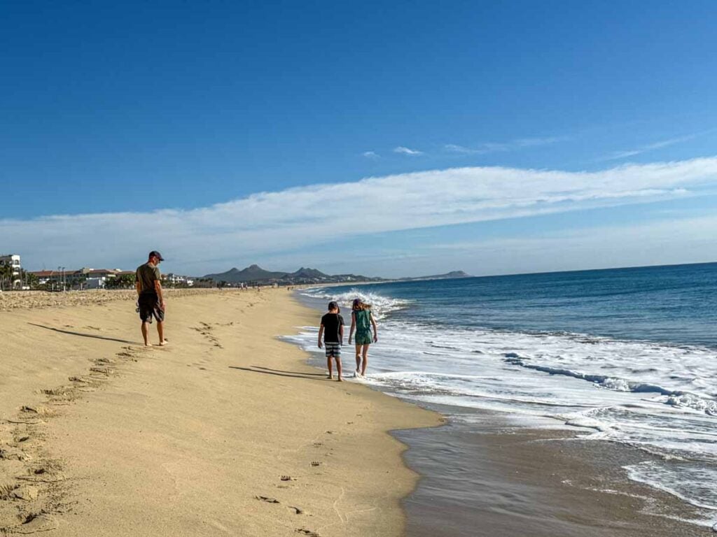 Dan Brewer, owner of FamilyCanTravel.com, walks on Playa Hotelera with kids kids on a family trip to San Jose del Cabo, Mexico.