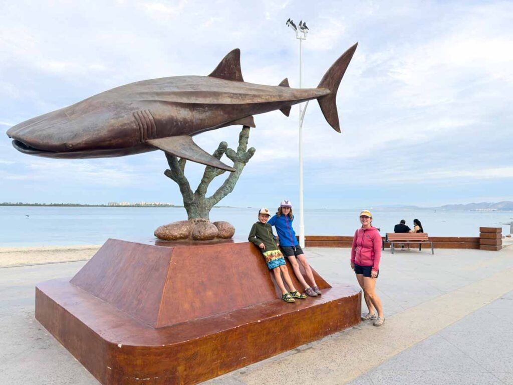 Celine Brewer and her kids stop near a whale shark statue on the Malecon in La Paz, Mexico.