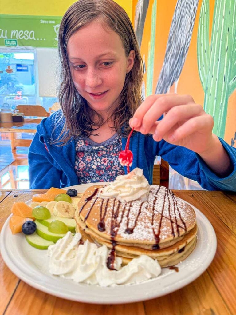 a 12-year old girl on a family trip to La Paz, Mexico, enjoys a pancake breakfast at La Chata Centro restaurant.