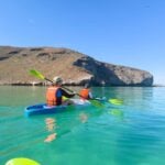 kayaking Playa Balandra in La Paz, Mexico with kids Celine Brewer, and her son, enjoy kayaking over turquoise water at Playa Balandra near La Paz, Mexico.