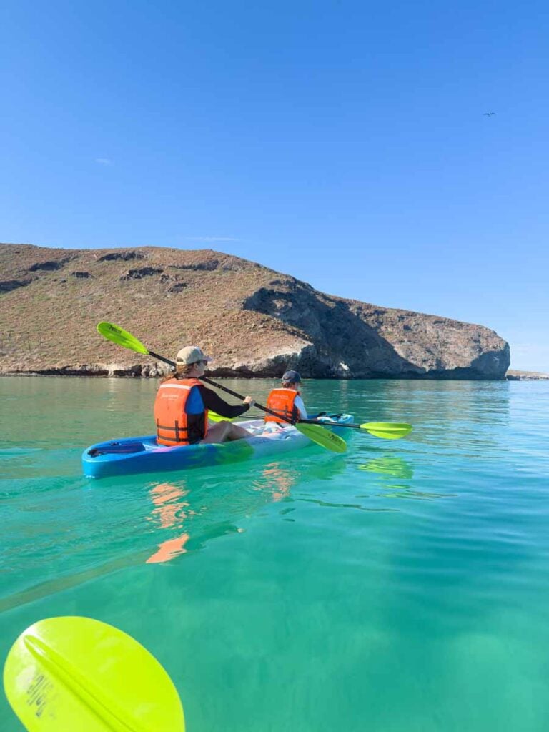 Celine Brewer, and her son, enjoy kayaking over turquoise water at Playa Balandra near La Paz, Mexico.