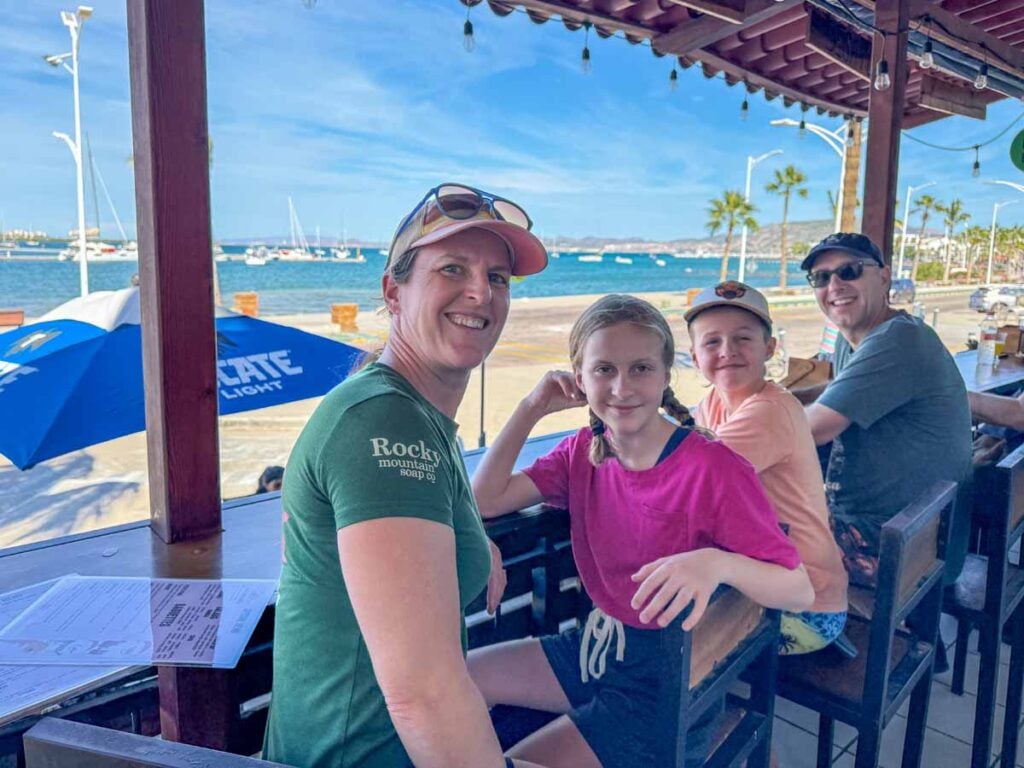 The Brewer family, from FamilyCanTravel.com, enjoys Christmas lunch by the ocean at Restaurante Vid'ah Bistro on a family trip to La Paz, Mexico.