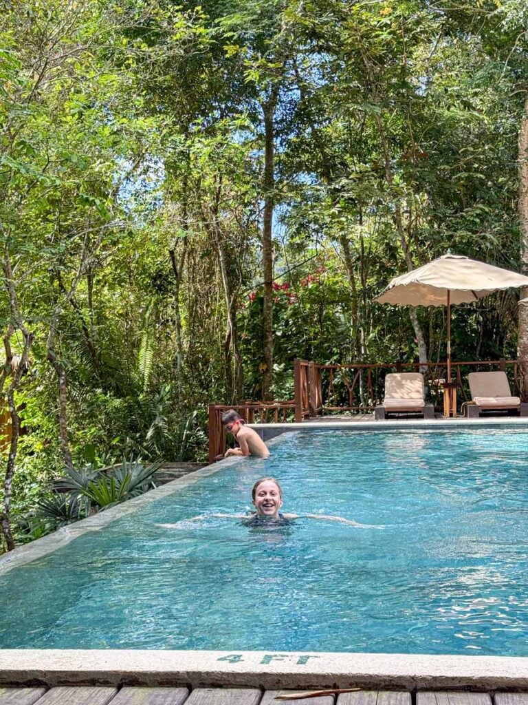 The Brewer kids, from the Family Can Travel blog, enjoy the jungle-side swimming pool during their 5-night stay at the Sweet Songs Lodge in San Ignacio, Belize.