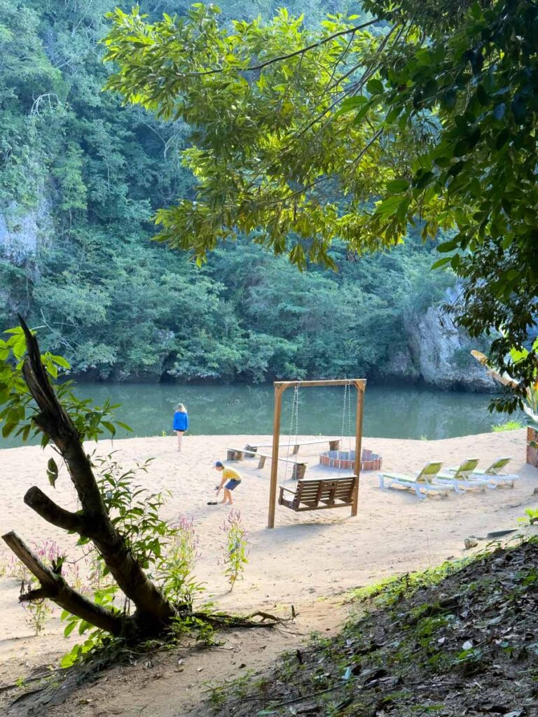 The Brewer kids, from the Family Can Travel blog, play on the real sand beach at the Sweet Songs Lodge in San Ignacio, Belize.