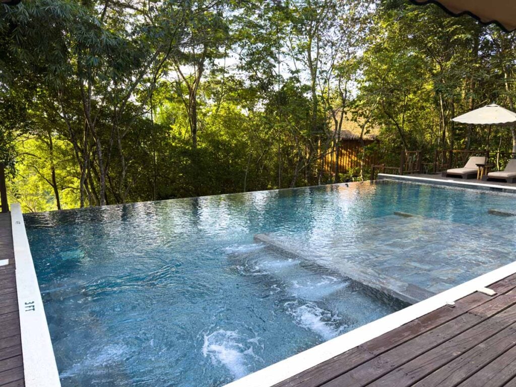 The beautiful natural setting for the infinity swimming pool at the Sweet Songs Jungle Lodge in San Ignacio, Belize.