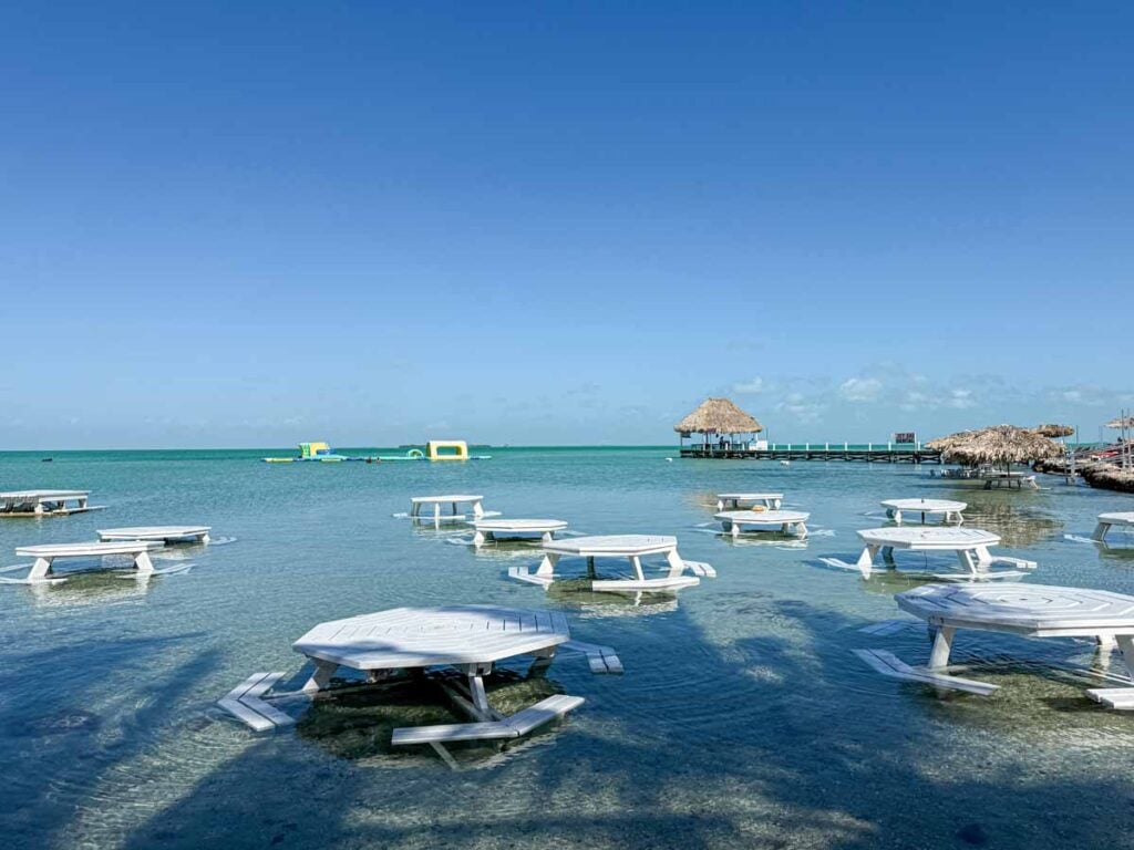 restaurant tables in the water at Secret Beach on Ambergris Caye, Belize.