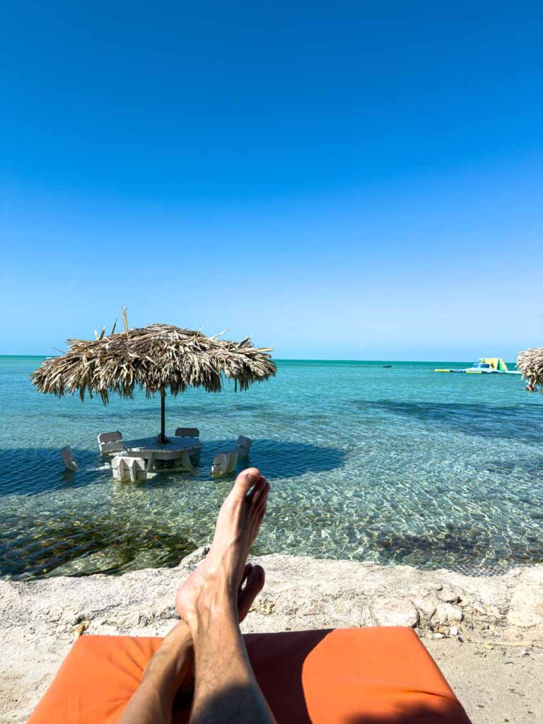 Dan Brewer relaxes on a beach chair at Secret Beach during a family trip to Ambergris Caye, Belize.
