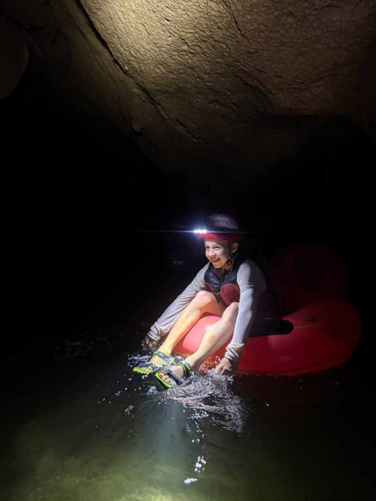 a 10-year old boy on a family trip to San Ignacio, Belize enjoys a cave tubing tour in Blue Hole National Park.