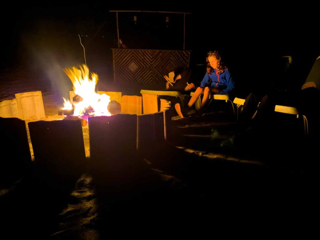 The Brewer family enjoys an evening bonfire on the beach during their stay at the Sweet Songs Lodge in San Ignacio, Belize.
