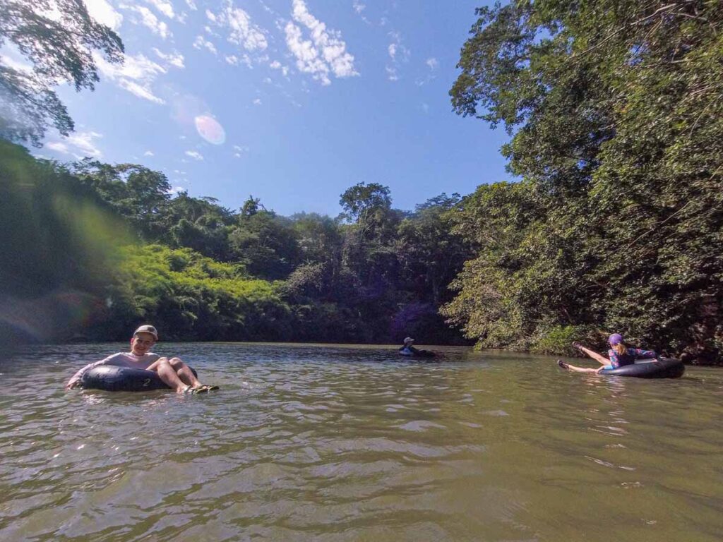 The Brewer family, from FamilyCanTravel.com, enjoys river tubing during their 5-night stay at the Sweet Songs Lodge in San Ignacio, Belize.