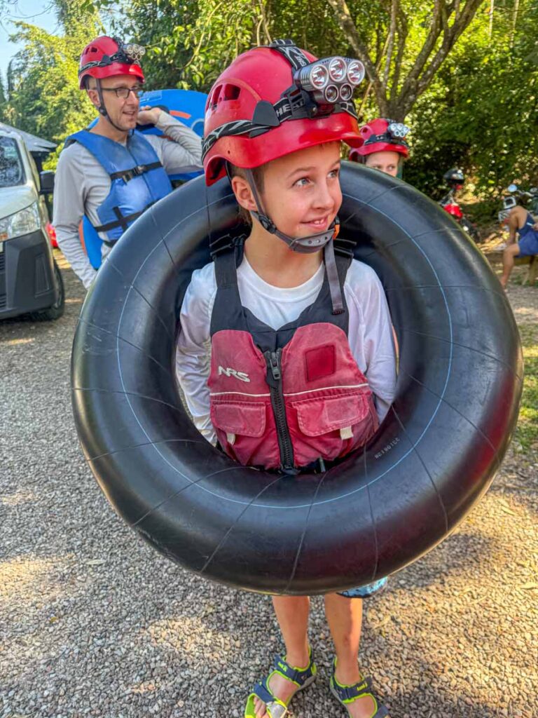 a 10-year old boy, from the Family Can Travel blog, is geared up and ready to go cave tubing at Blue Hole National Park, Belize.