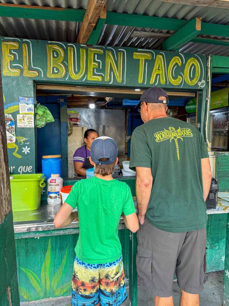 Dan Brewer, owner of FamilyCanTravel.com, and his son place an order at El Buen Taco on Ambergris Caye.