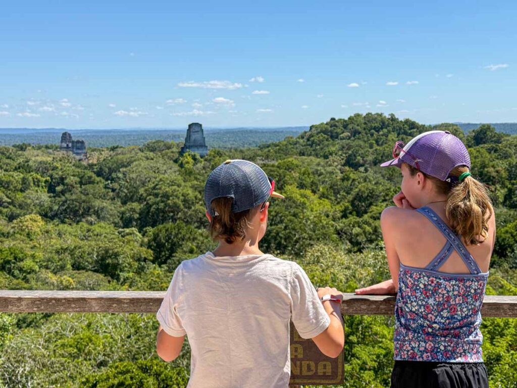 The Brewer kids, from FamilyCanTravel.com, look at the tops of pyramids on a day trip to Tikal from San Ignacio, Belize.