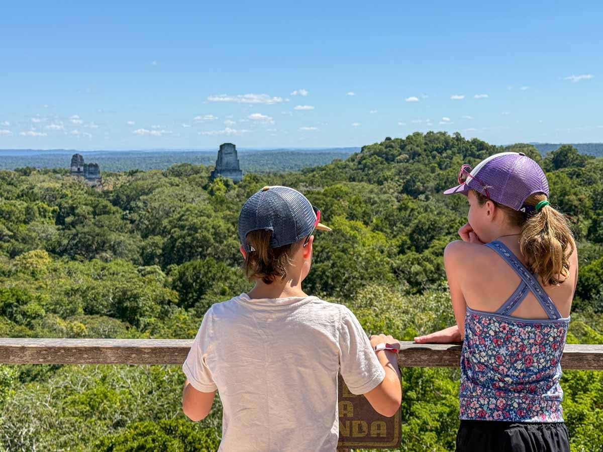 The Brewer kids, from FamilyCanTravel.com, look at the tops of pyramids on a day trip to Tikal from San Ignacio, Belize.