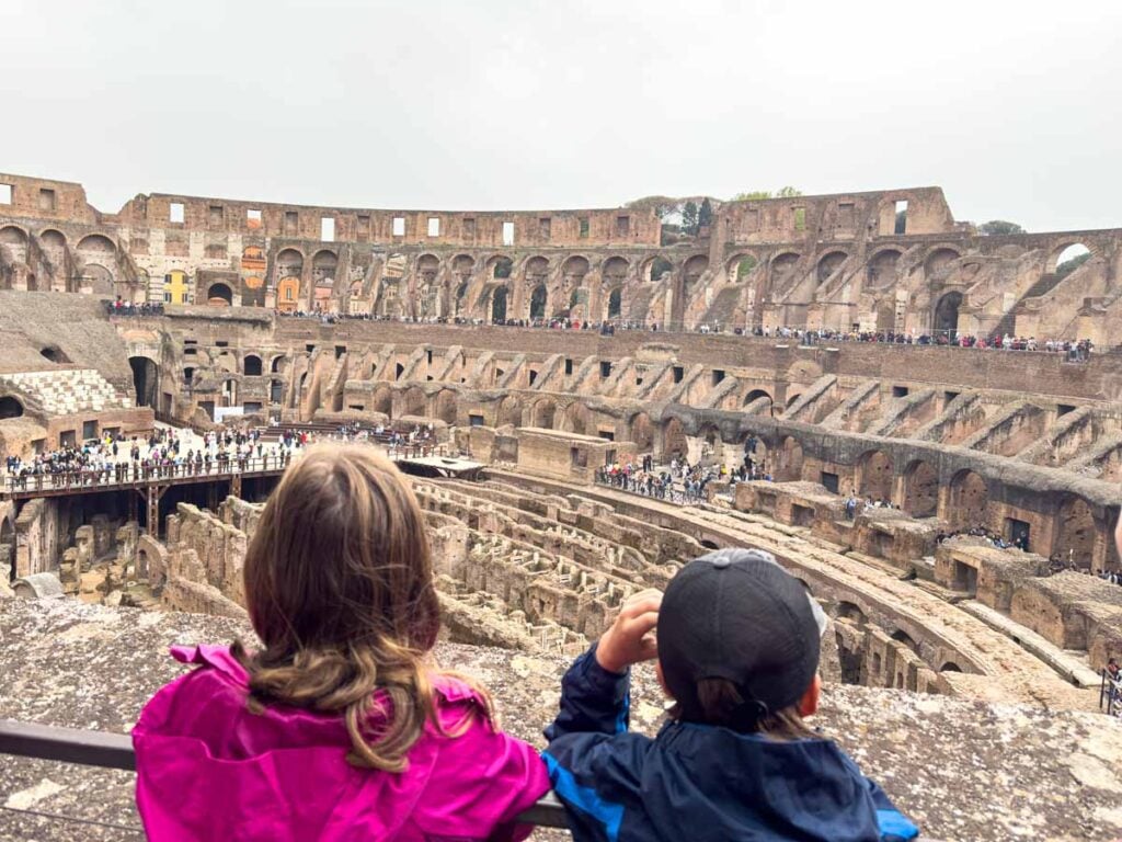 The Brewer kids look down on the Colosseum from the second floor.