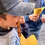 24 Hours in Rome with kids - Rome Food Tour - Lamb Skewers One of the Brewer kids tries a lamb skewer on a family-friendly food tour of Rome.
