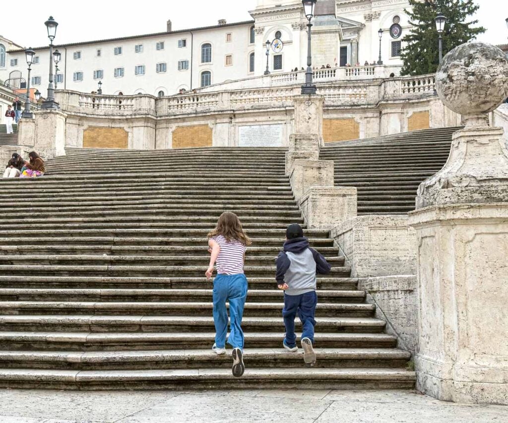 The Brewer kids, from Family Can Travel, race each other on the Spanish Steps.