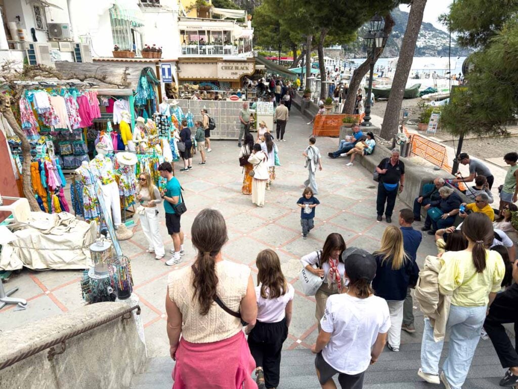 Celine Brewer and her kids walk the oceanfront shopping street in Positano, along Italy's Amalfi Coast.