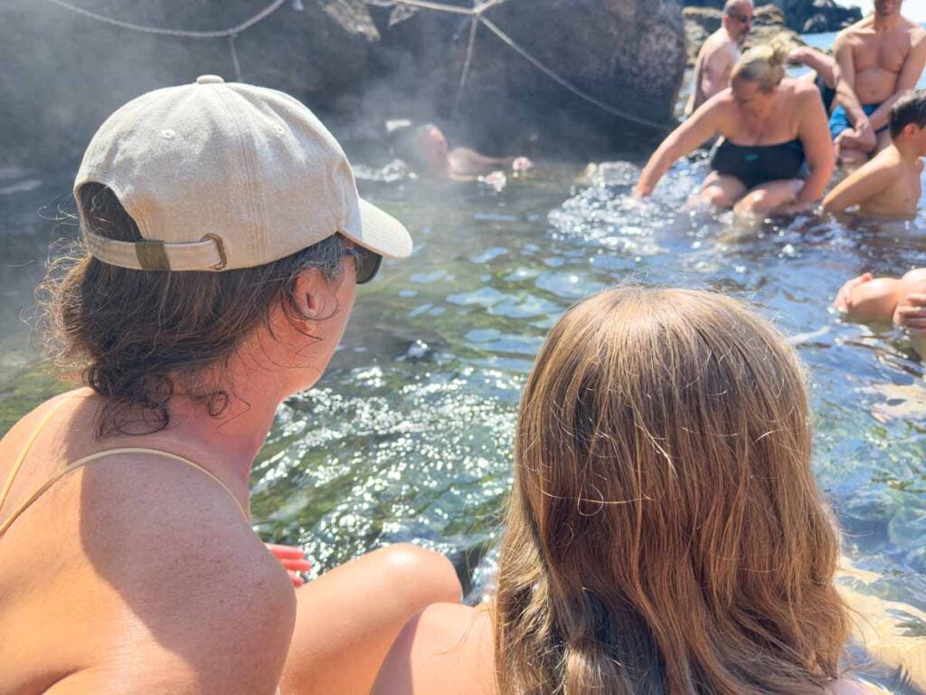 Celine Brewer and her daughter soak in the ocean hot springs at Sorgeto Bay, Ischia.