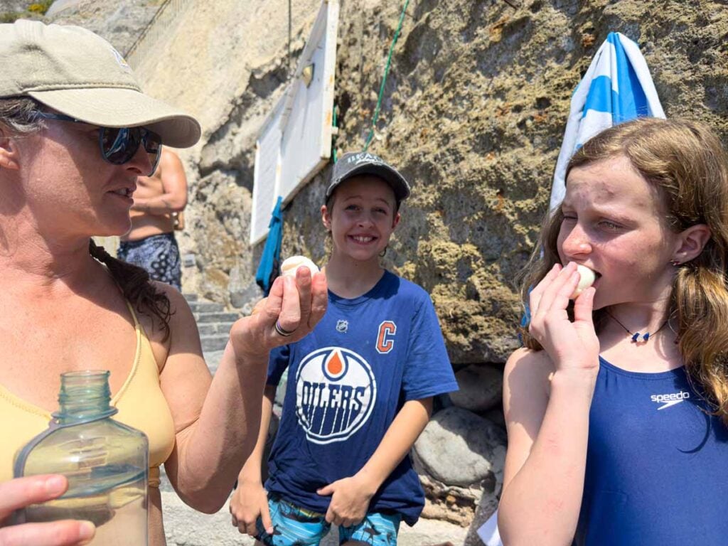 The Brewer family, from the Family Can Travel blog, eats hard boiled eggs cooked in the natural hot springs at Sorgeto Bay, Ischia.