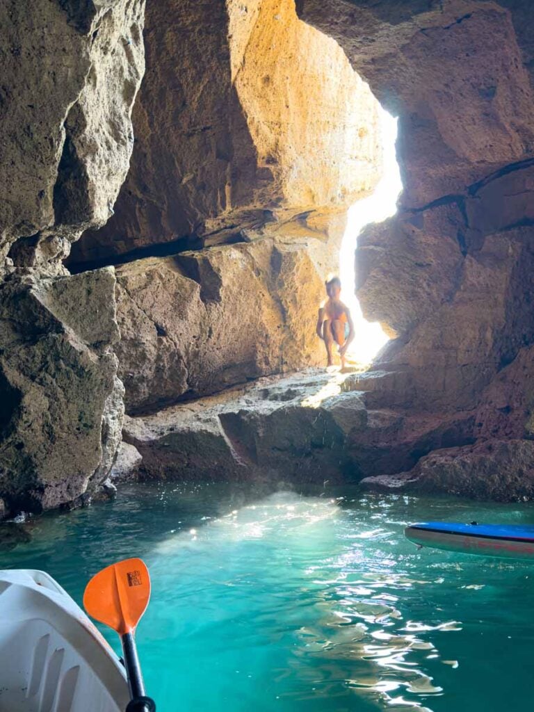 One of the Brewer kids jumps into the ocean from inside a cave on a kayak tour on Ischia, Italy.