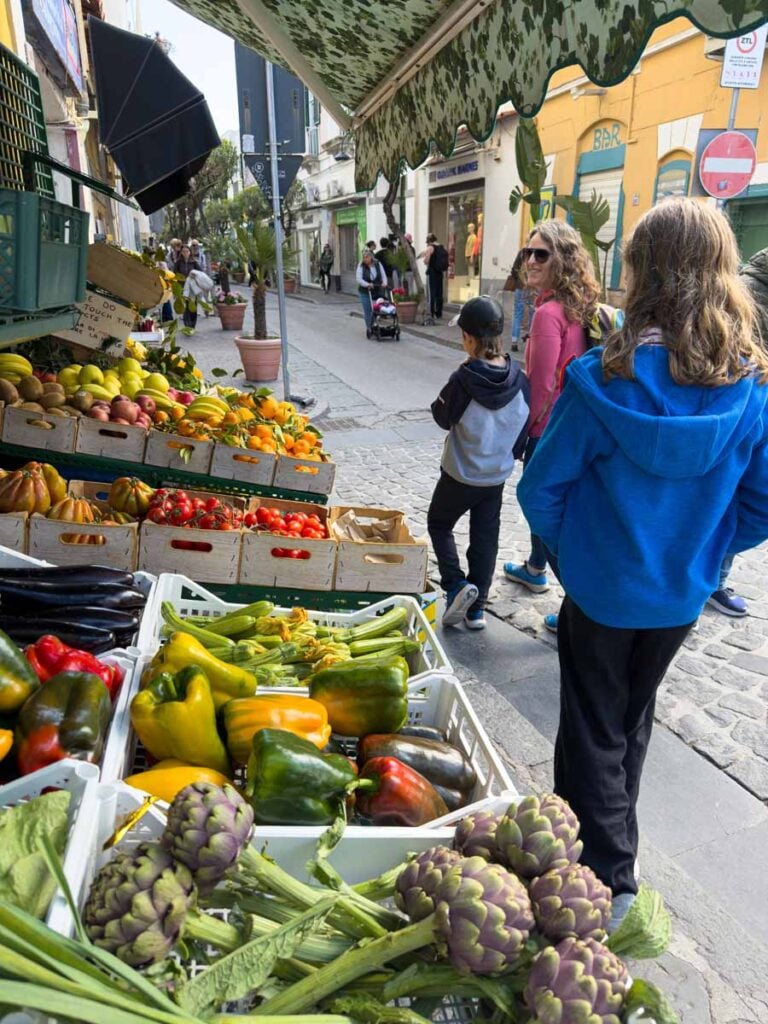Celine Brewer, owner of FamilyCanTravel.com, enjoys a family walk along Via Roma, the main shopping street in Ischia, Italy.