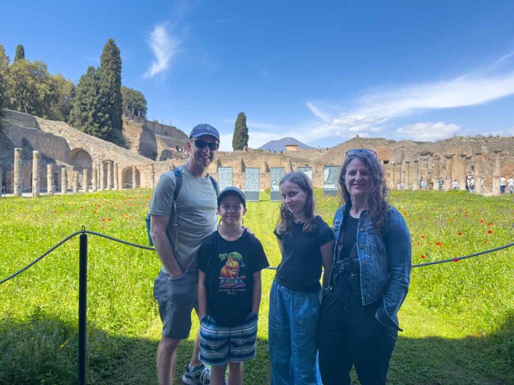 Dan and Celine Brewer, owners of the Family Can Travel blog, visit the Gladiator School in the Pompeii ruins during a family trip to Italy.