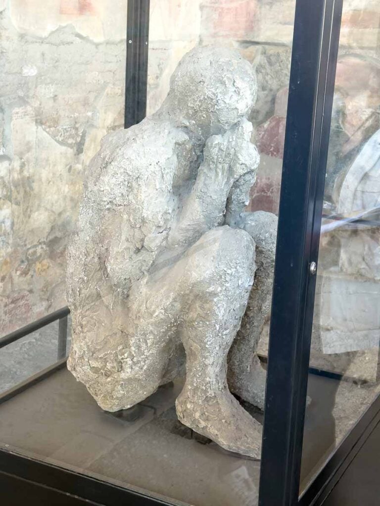 a Pompeii plaster cast body in the fetal position.