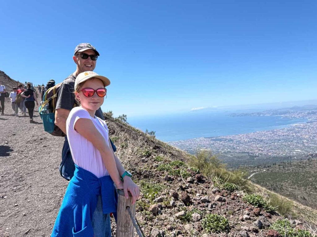 Dan Brewer, owner of Family Can Travel, admires views of Naples while hiking with his daughter to the summit of Mt. Vesuvius.
