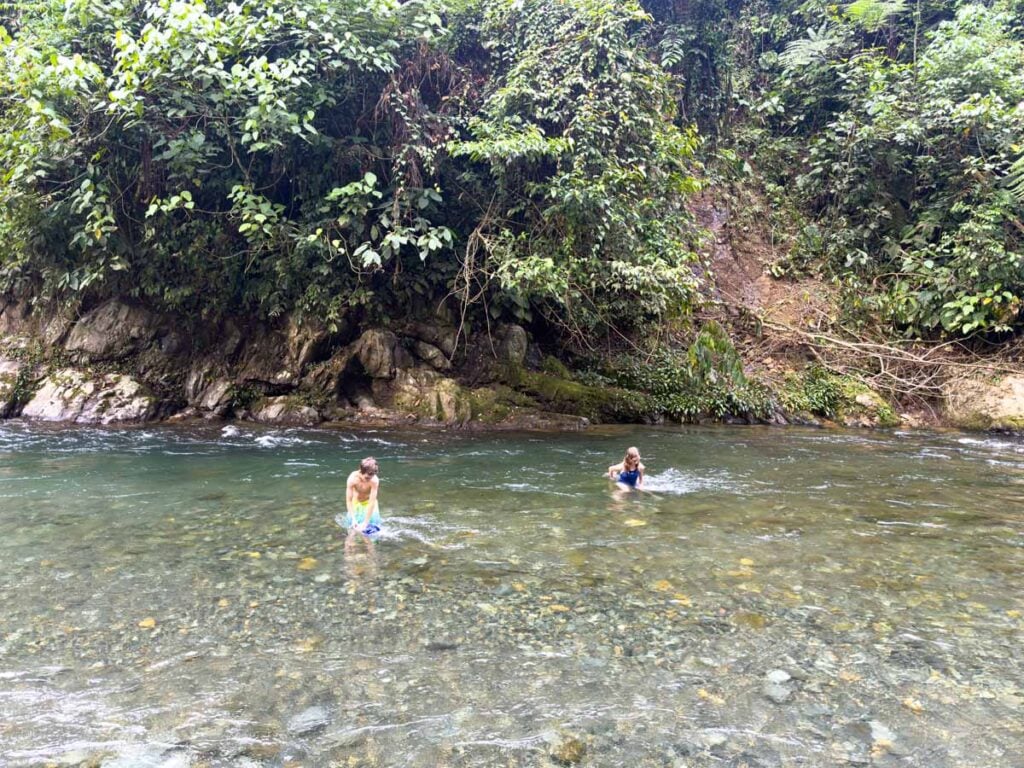 The Brewer kids cool down in a river after a challenging jungle hike in Gunung Leuser National Park to see orangutans.