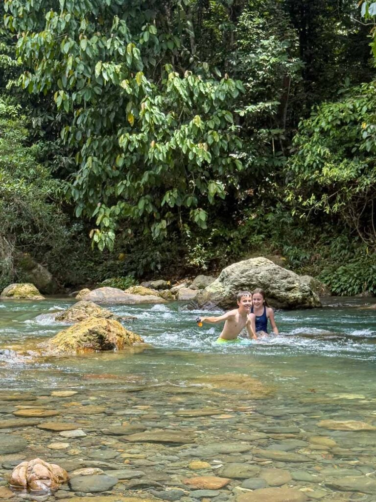 The Brewer kids play in the river water at the Tangkahan Hot Springs in Sumatra, Indonesia.