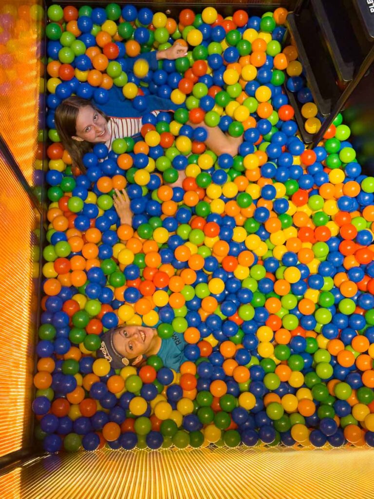 The Brewer kids, from FamilyCanTravel.com, play in the ball pit in the lobby of the very family-friendly lyf Funan Singapore hotel.
