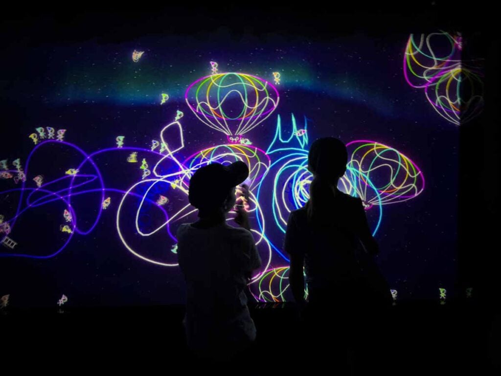 The Brewer kids look at their futuristic art creations at the Future World Exhibit at the ArtScience Museum in Singapore.