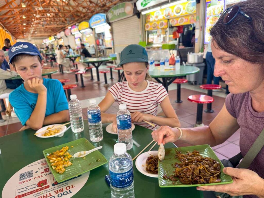 Celine Brewer, owner of FamilyCanTravel.com, serves up dishes we got to try on our food tour at Maxwell Food Centre.