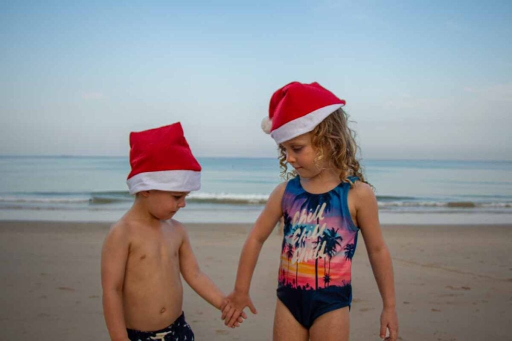 The Brewer kids wear Santa hats on the beach on Christmas Day in Phuket, Thailand.