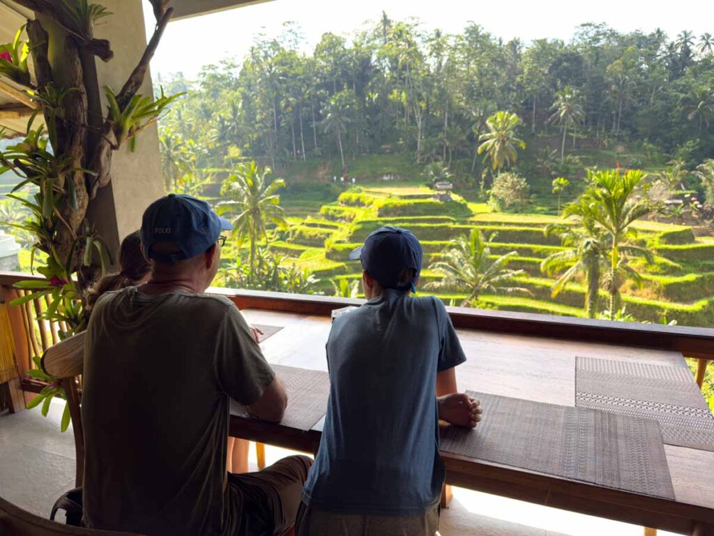 Dan Brewer, owner of the Family Can Travel blog, enjoys breakfast with his family overlooking the Tegallalang Rice Terraces.