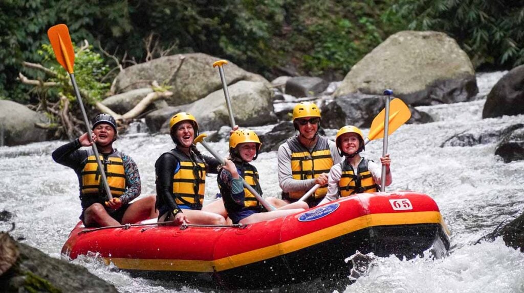 Dan and Celine Brewer, owners of FamilyCanTravel.com, and their kids enjoy white water rafting during a family trip to Bali, Indonesia.