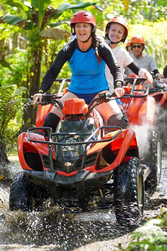 Celine Brewer and her son ride an ATV through the jungle on a kid-friendly ATV tour in Bali.