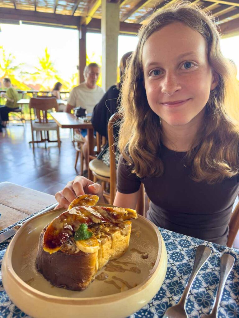 A Brewer child eating French toast at the Pistachio breakfast restaurant in Ubud, Indonesia.