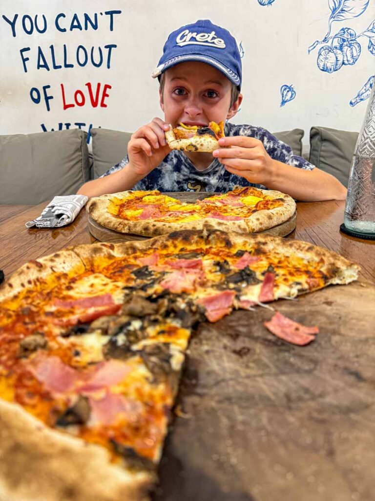 A Brewer child eats pizza at the kid-friendly Umah Pizza restaurant in Ubud.