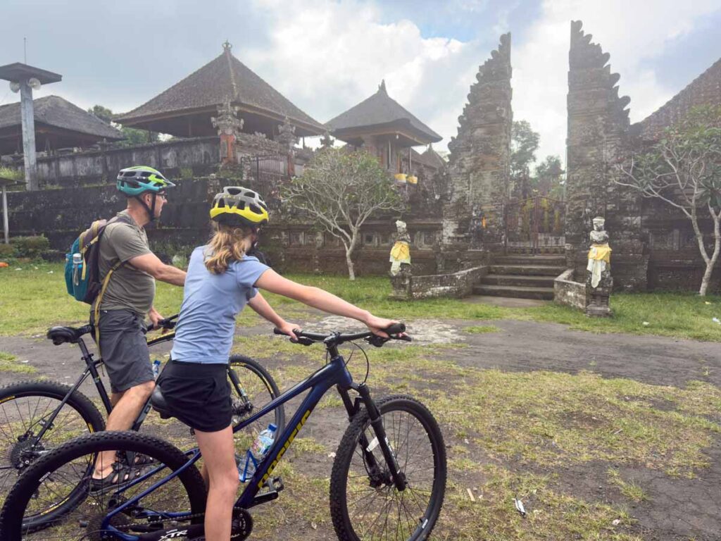 Dan Brewer and his daughter stop to look at a temple on a family-friendly bike tour in Bali.